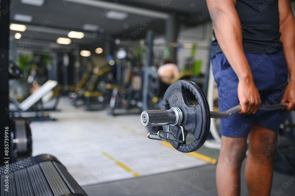 Athletic black guy making weightlifting or powerlifting at modern gym Athletic black guy making weightlifting or powerlifting at modern gym