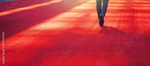 Businessman walking on red ...