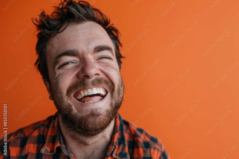 Portrait of a smiling caucasian man in his 30s laughing isolated on solid color backdrop Portrait of a smiling caucasian man in his 30s laughing isolated on solid color backdrop