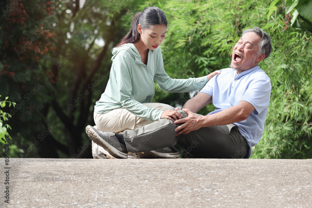 Painful elderly Asian man get hurt during exercise with daughter at park. Grandpa exercising outdoors in garden but get injured, grandchild try to help him. Senior need treatment for muscular aches. Painful elderly Asian man get hurt during exercise with daughter at park. Grandpa exercising outdoors in garden but get injured, grandchild try to help him. Senior need treatment for muscular aches.