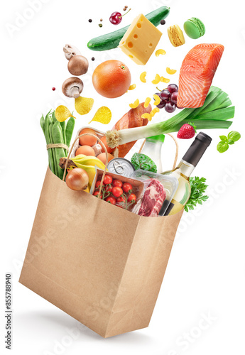 Food or groceries flying out from paper shopping  bag  on white background. File contains clipping paths.