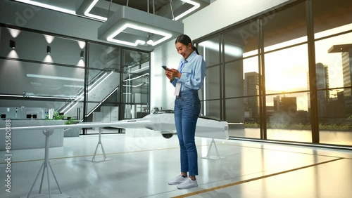 Wallpaper Mural Full Body Side View Of An Asian Female Professional Worker Standing With Her Phone With Drone Project, High-tech Industrial Facility, She Raises Her Fist Up With Screaming Goal Torontodigital.ca