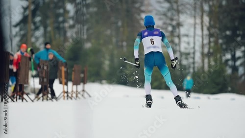 Athlete skiing. Ski competition. Shot from behind photo