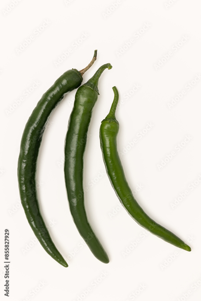 Three green hot chili peppers on white Three green hot chili peppers on white