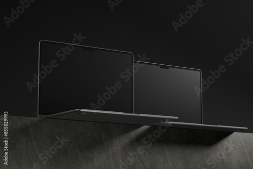 Three Black Laptops on a Gray Surface