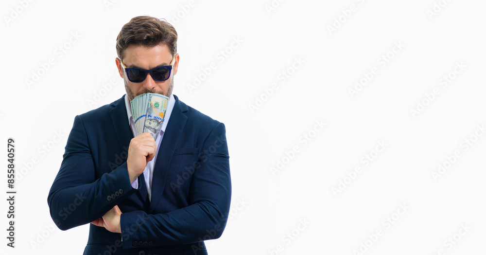 Man in suit with money cash. Dollar banknotes. Portrait of man holding american money banknotes. Dollar bills, credit, online banking. Rich man point at dollar banknotes, bank loan, financial savings. Man in suit with money cash. Dollar banknotes. Portrait of man holding american money banknotes. Dollar bills, credit, online banking. Rich man point at dollar banknotes, bank loan, financial savings.