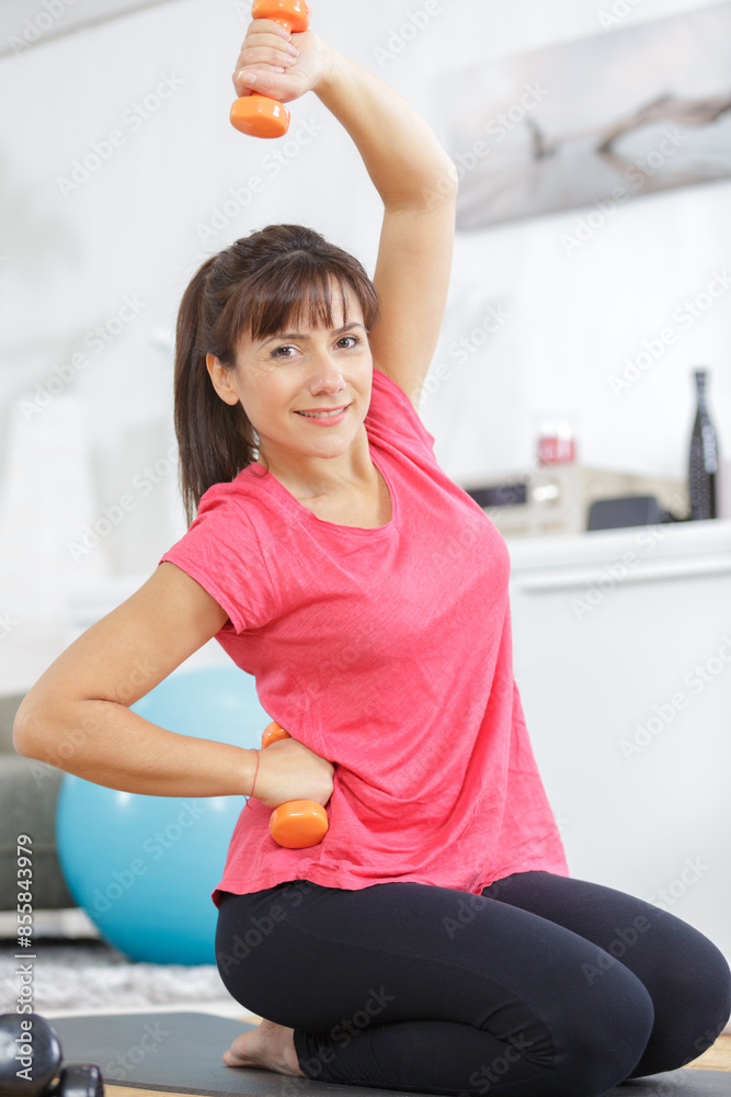 a woman exercising with dumbbells a woman exercising with dumbbells