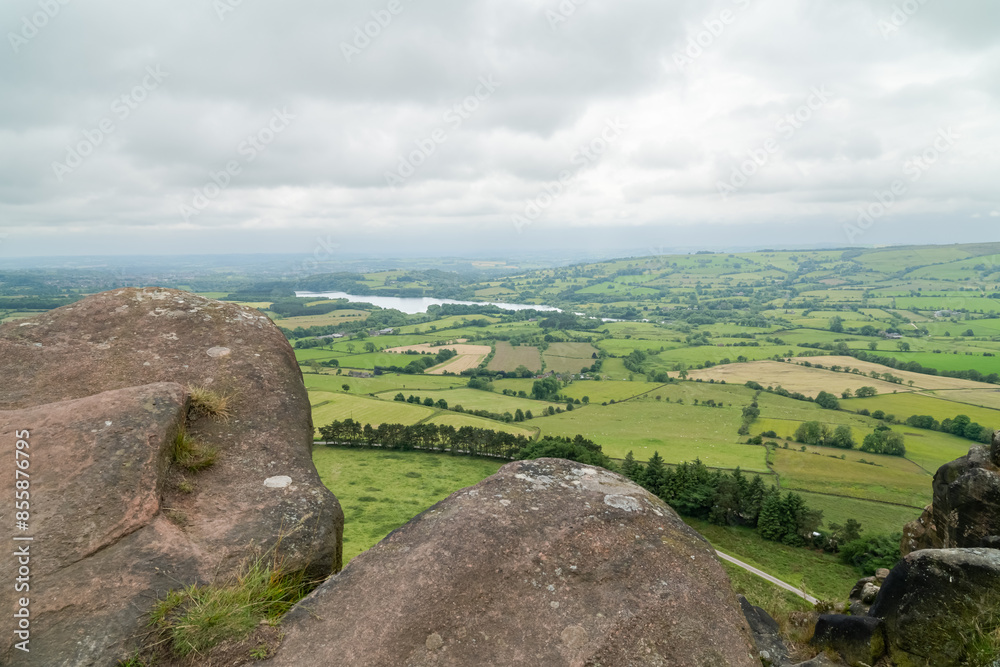 The Peak District countryside in Staffordshire, UK with Tittersworth Reservoir in the background and the rocks of Hen Cloud in the foreground The Peak District countryside in Staffordshire, UK with Tittersworth Reservoir in the background and the rocks of Hen Cloud in the foreground