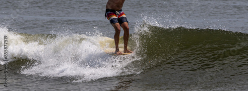 Hanging ten on a surfboard photo