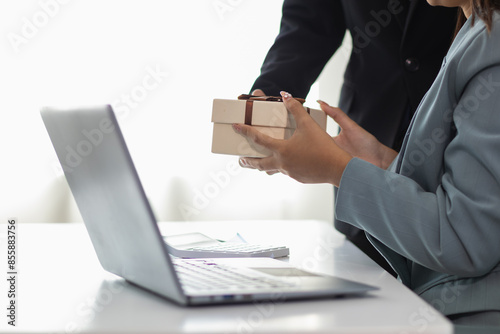young manager prepared gift box to give to the beautiful secretary in the office to express the love and friendship they had shared between working together for long time. Friendship and love concept