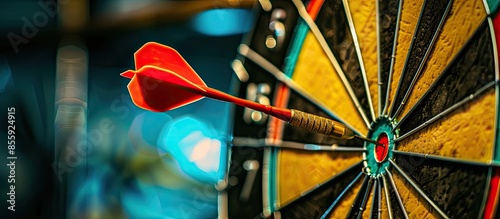 bullseye target or dart board has red dart arrow throw hitting the center of a shooting for business targeting and winning goals business concepts. Copy space image. Place for adding text or design