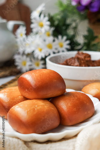 Fried Mantou served in white plate with Beef Rendang.  Fusion food. photo