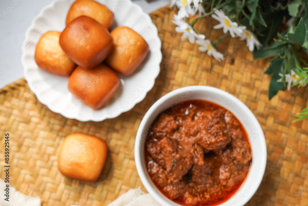 Fried Mantou served in white plate with Beef Rendang. Fusion food. Fried Mantou served in white plate with Beef Rendang. Fusion food.