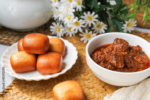 Fried Mantou served in white plate with Beef Rendang.  Fusion food.