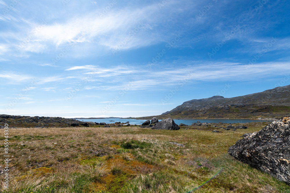 Greenland Nanortalik arctic lava stones volcanic mountain landscape on a sunny day with feather clouds Greenland Nanortalik arctic lava stones volcanic mountain landscape on a sunny day with feather clouds