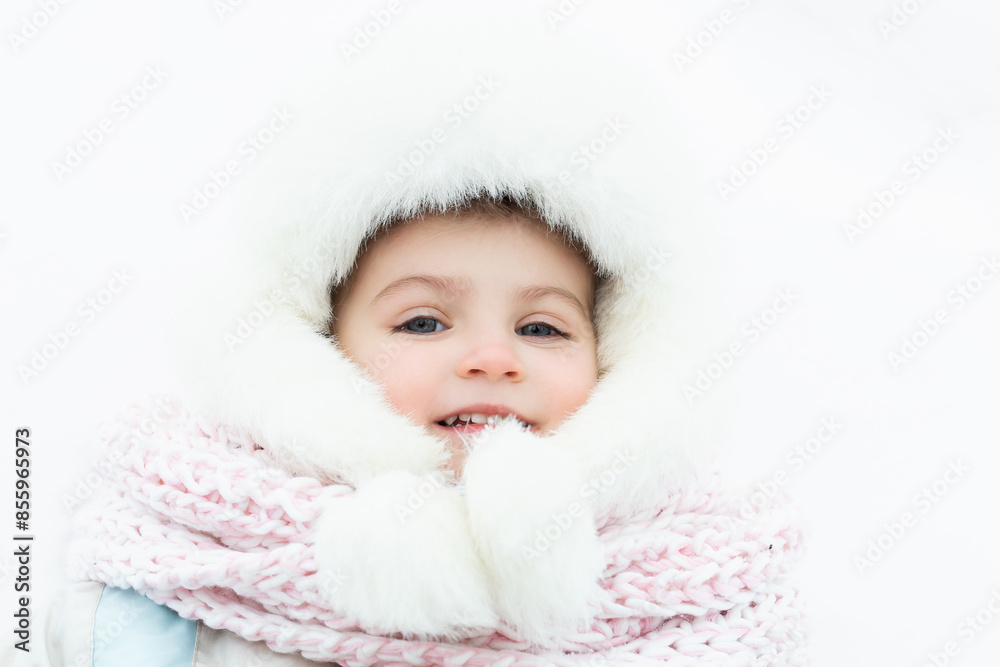 A cute baby in a snowy winter forest. Little girl having fun on winter day. Happy child in winter park A cute baby in a snowy winter forest. Little girl having fun on winter day. Happy child in winter park