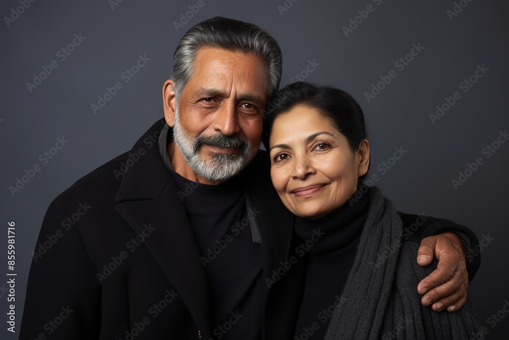 A man and woman are posing for a picture A man and woman are posing for a picture