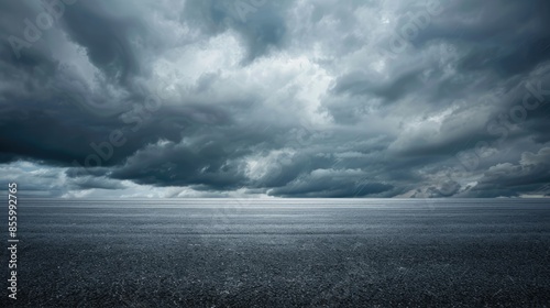 Dramatic Clouds Fill the Sky over Empty Dark Asphalt Street Background