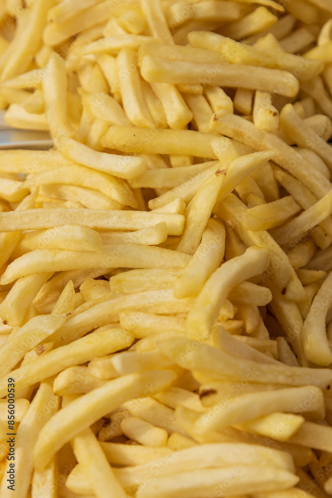 fried french fries in oil as background. fried french fries in oil as background.