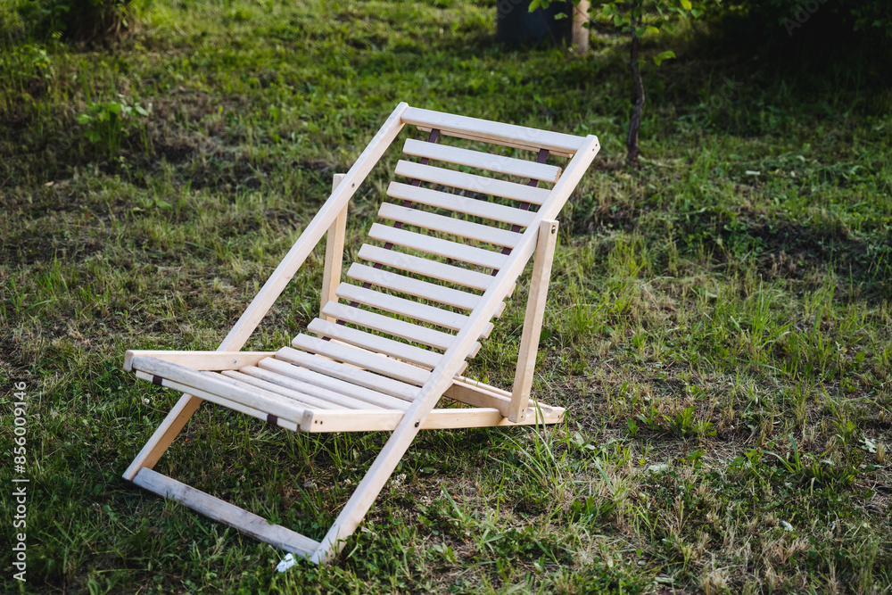 The wooden deck chair brings tranquility to the scenic meadow, seamlessly merging with nature for a serene outdoor escape, providing comfort and relaxation amidst the lush surroundings The wooden deck chair brings tranquility to the scenic meadow, seamlessly merging with nature for a serene outdoor escape, providing comfort and relaxation amidst the lush surroundings