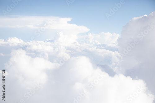 Sunrise above textured clouds from airplane window