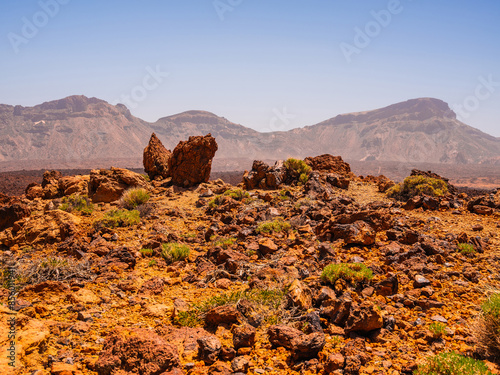 spot in Tenerife with many red rocks and beautiful mountain landscape background photo