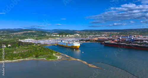 Photos AERIAL: White and yellow freight ship loading cars from Koper port parking lot