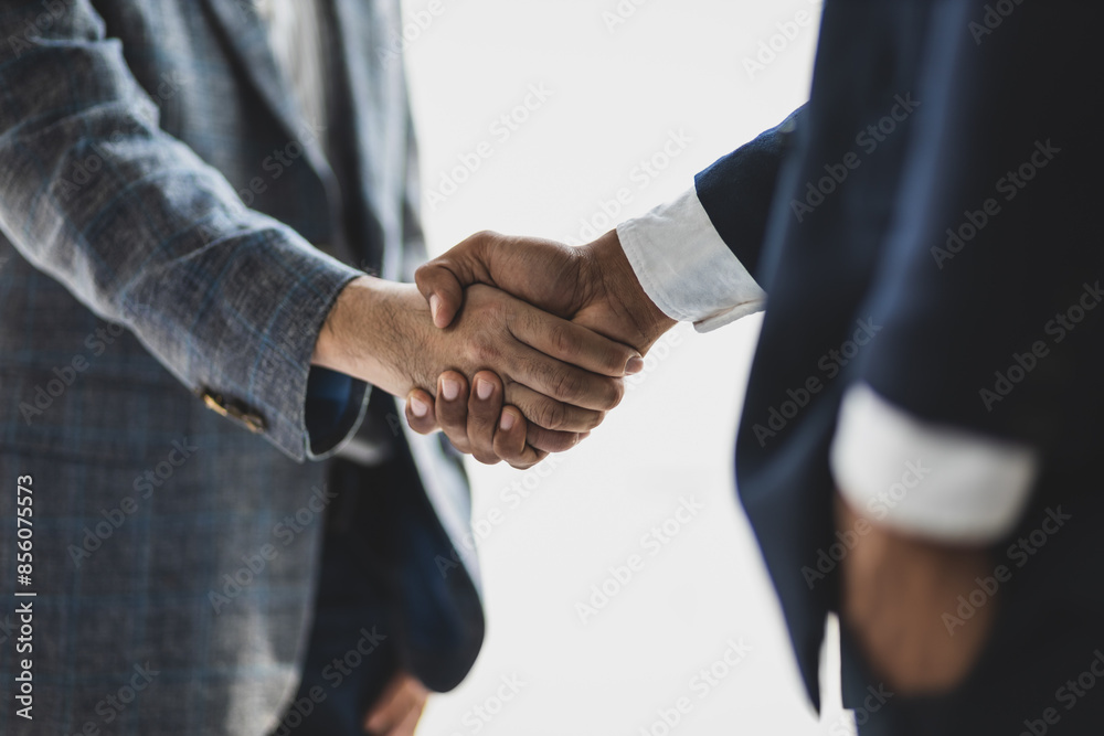 Business partners shaking hands in a meeting. Business and financial cooperation. Business partners shaking hands in a meeting. Business and financial cooperation.