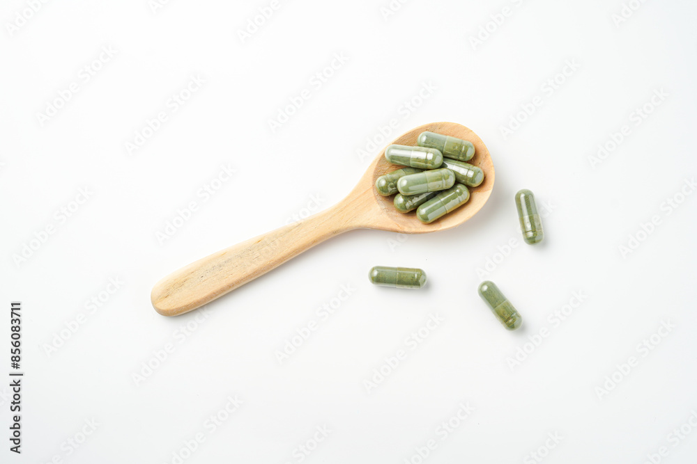 Herbal capsules in wooden spoon, Natural herbs, Alternative Medicine, Herbal supplement Herbal capsules in wooden spoon, Natural herbs, Alternative Medicine, Herbal supplement