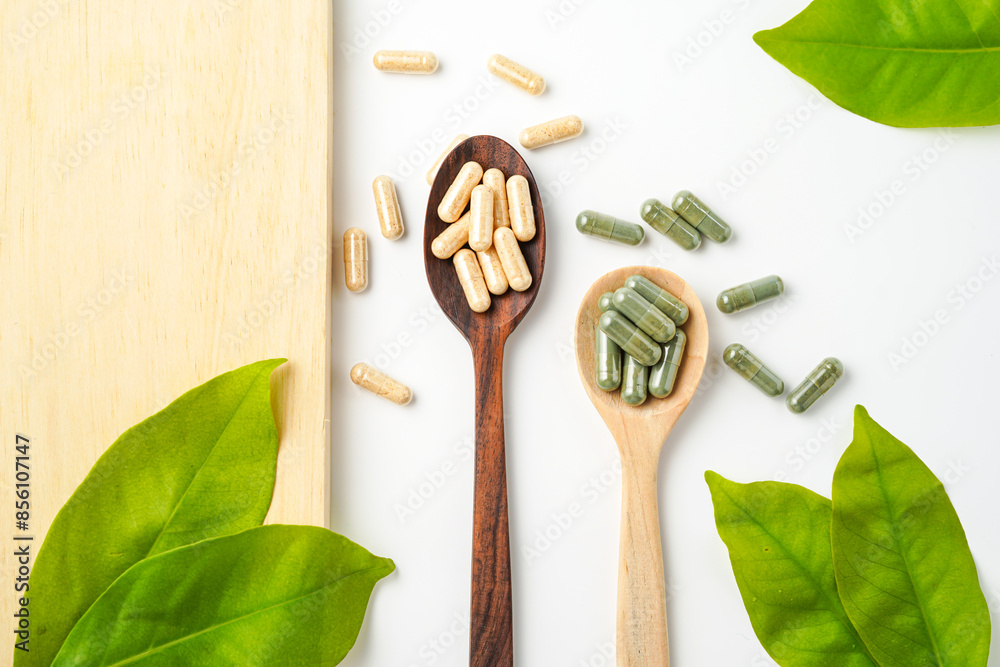 Herbal capsules in wooden spoon, Natural herbs, Alternative Medicine, Herbal supplement Herbal capsules in wooden spoon, Natural herbs, Alternative Medicine, Herbal supplement
