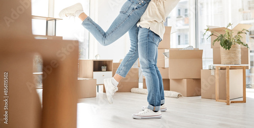 Happy, legs and couple hug in new house success, real estate and love for gratitude of property investment. Care, woman and man with embrace, support and bonding for homeowner security celebration © peopleimages.com