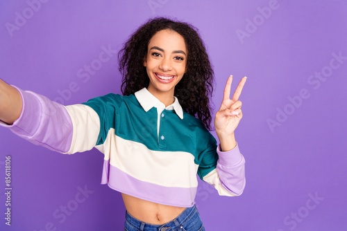 Portrait of lovely young girl make selfie v-sign wear shirt isolated on purple color background