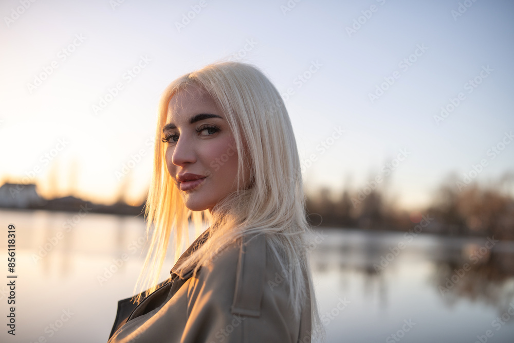 Portrait of a young beautiful blonde girl in a dress by the river. Portrait of a young beautiful blonde girl in a dress by the river.