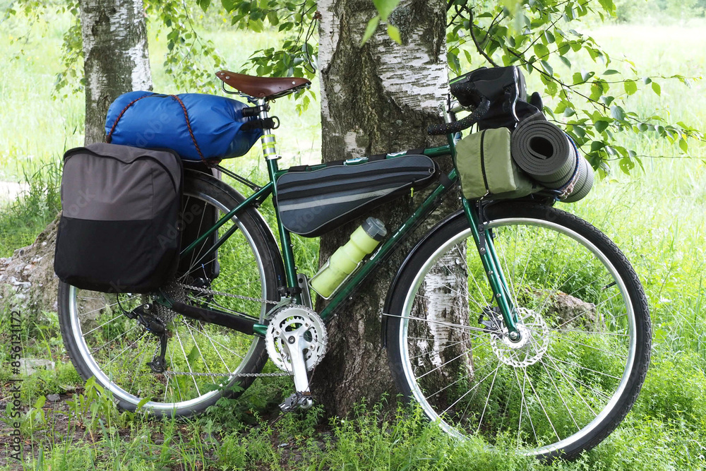 A bicycle hung with travel gear. Cycle equipment for traveling. A mountain bike hung for hiking. A bicycle hung with travel gear. Cycle equipment for traveling. A mountain bike hung for hiking.