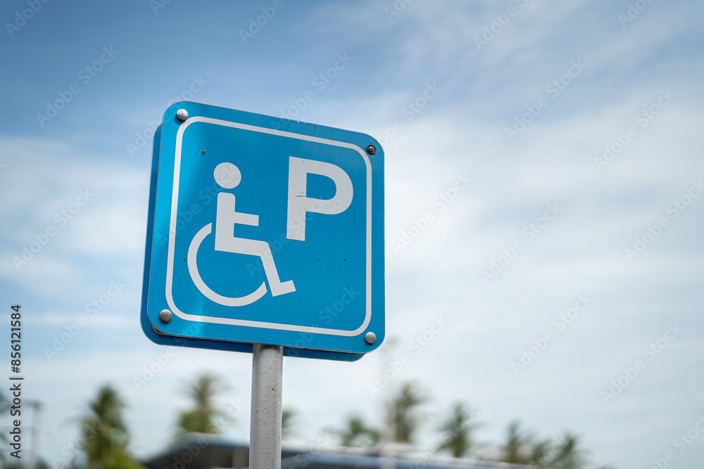 Wheelchair icon symbol signpost at car parking place, reserved for disability person. Transportation symbol object, close-up. Wheelchair icon symbol signpost at car parking place, reserved for disability person. Transportation symbol object, close-up.