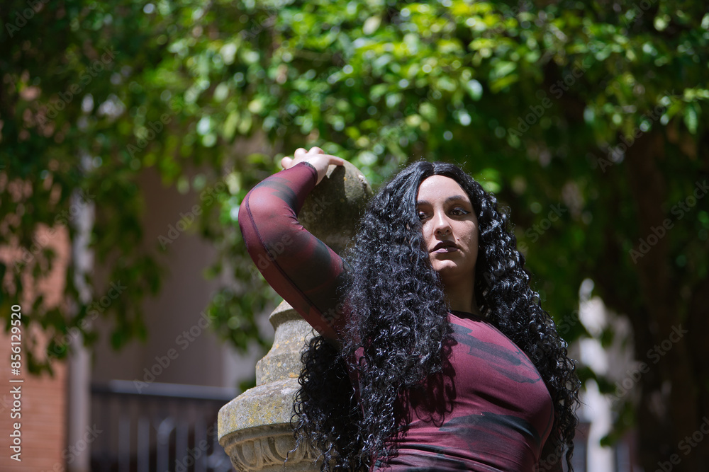 Portrait of young, beautiful, alternative, chubby woman in a red dress ...