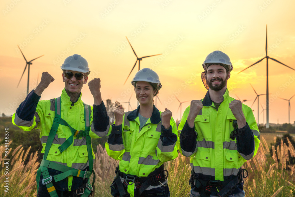 Team Engineers men and woman checking and inspecting on construction with sunset sky. people operation. Wind turbine for electrical of clean energy and environment. Industrial of sustainable.
