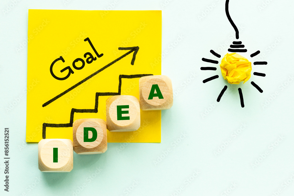 Idea, Concept of developing an idea for a career or dream, Hand-painted stairs and light bulb symbol, Wooden blocks with the word Idea, close up, copy space, Beautiful blue background