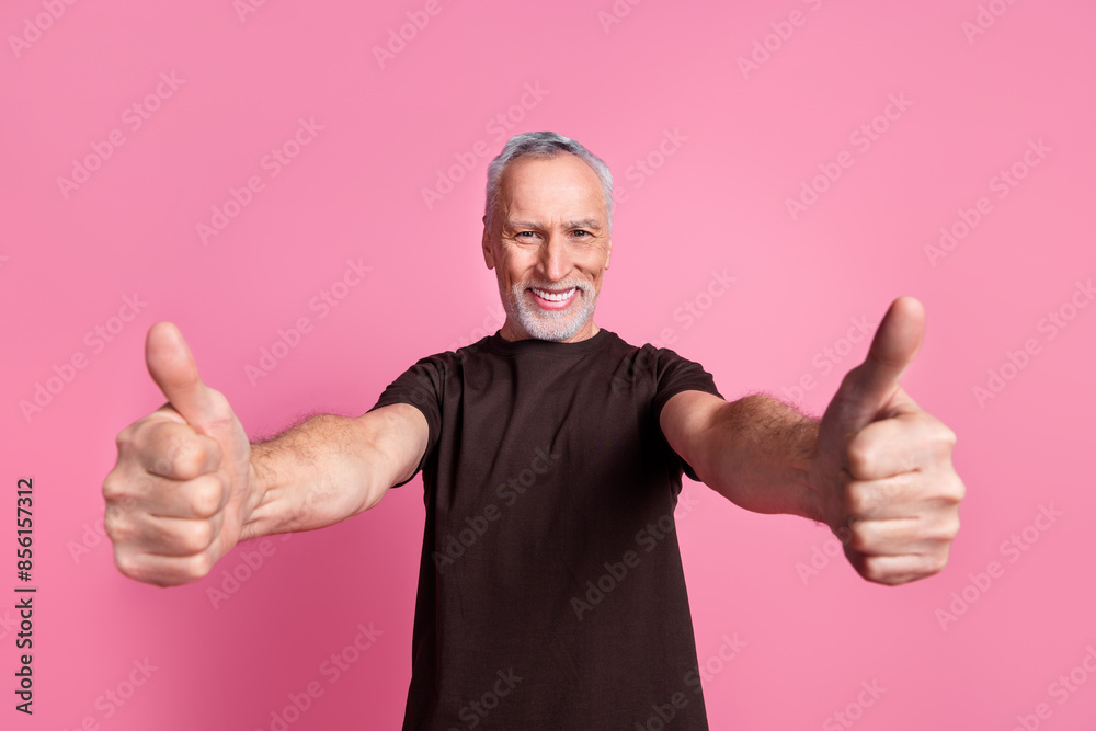 Portrait of positive man with white gray beard dressed brown t-shirt show you thumbs up approve nice job isolated on pink color background