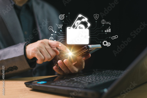 Digital wallet payment icon on internet mobile banking, online wallet business concept. Man hold smartphone and computer laptop with online money transaction application. Bank e-commerce investment