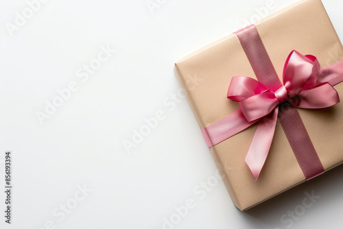Flat lay of a gift box with ribbon, minimalist design with empty space © Porawit