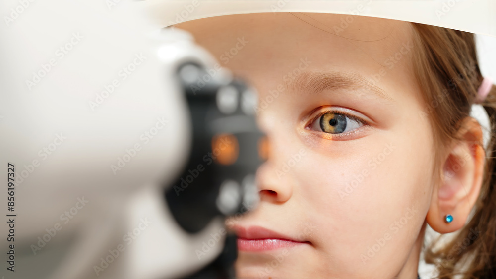 Eye iris and pupil macro. Reflected moving light rays into the child eye with zoom. Close up. The concept of ophthalmology and medicine. Medical attendance at the optometrist in a bright modern clinic Eye iris and pupil macro. Reflected moving light rays into the child eye with zoom. Close up. The concept of ophthalmology and medicine. Medical attendance at the optometrist in a bright modern clinic