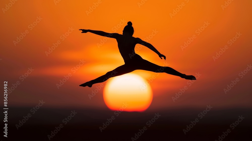 Elegant silhouette of an acrobat in a graceful mid-air pose, against a backdrop of the setting sun, highlighting the smooth and agile movement Elegant silhouette of an acrobat in a graceful mid-air pose, against a backdrop of the setting sun, highlighting the smooth and agile movement