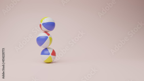 Three beach balls stacked on top of each other, balancing delicately against a clear background with ample copy space on one side.