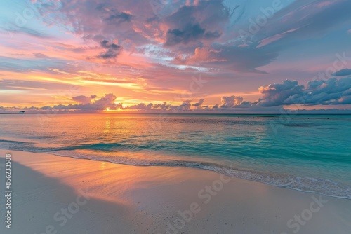 A vibrant sunrise over a pristine tropical beach, with the sky and water illuminated in soft colors, highlighting a new day