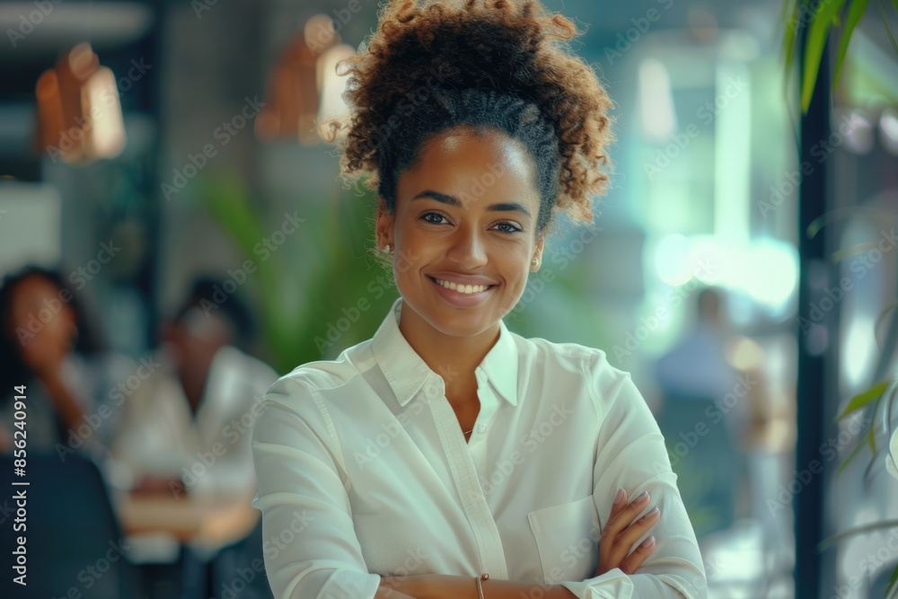 Confident African American businesswoman at office desk with colleagues. Confident African American businesswoman at office desk with colleagues.