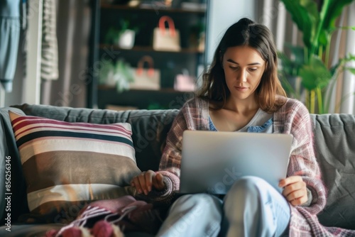 Relaxed woman browsing on laptop at home photo