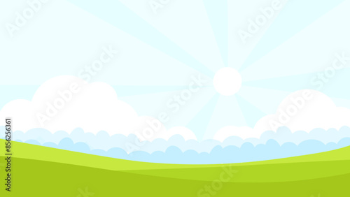 Green fields summer landscape with sun rays in the background