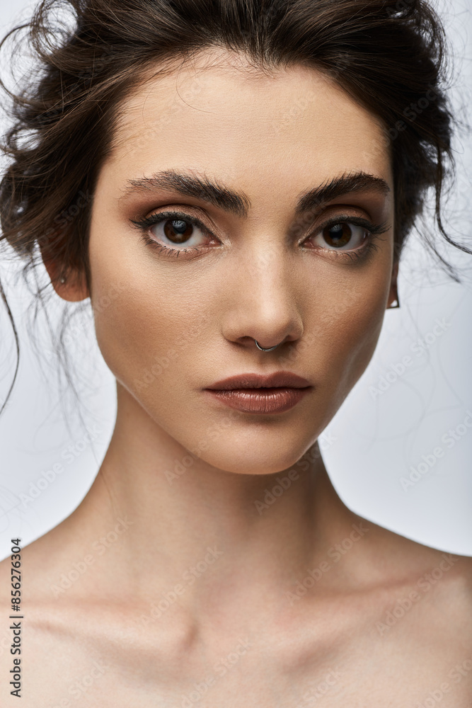 Naklejka premium A close-up portrait of a young woman with a nose ring.