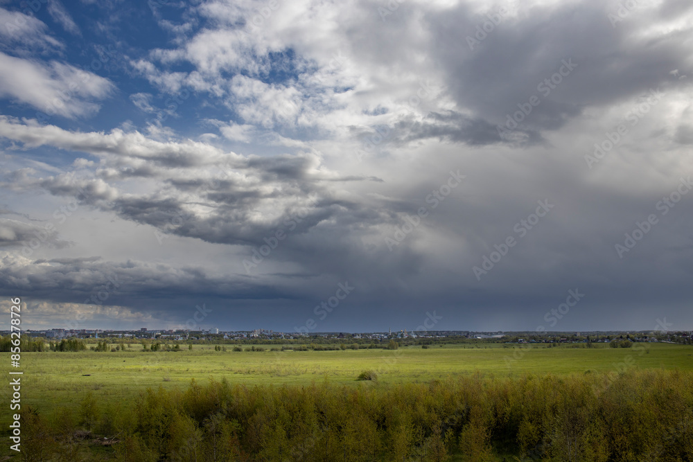 A field with a cloudy sky in the background A field with a cloudy sky in the background